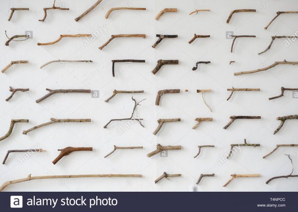 wooden-sticks-in-the-shape-of-guns-hanging-on-a-wall-in-amsterdam-T4NPCC.jpg